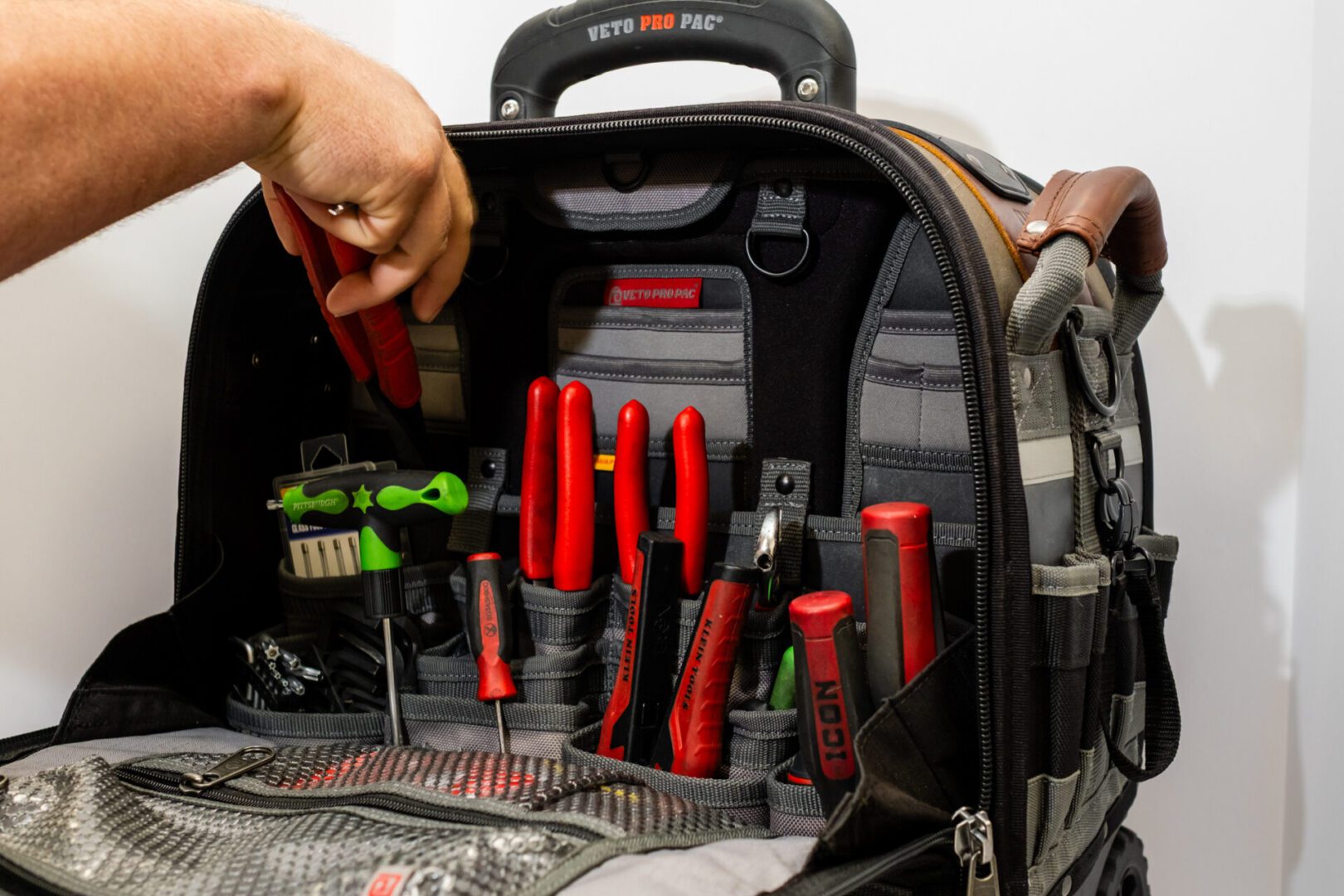 Tool bag with various hand tools displayed.